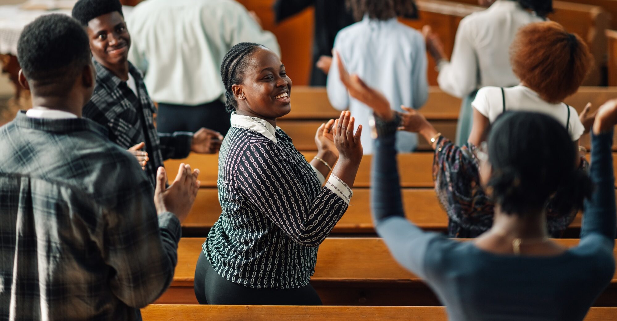 A congregation singing and clapping together